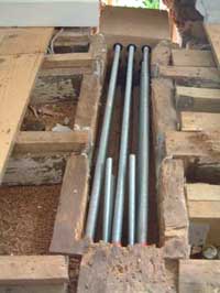 Steel High Tensile Rods inside a dug our carrier beam waiting for Structural Epoxy Resin to be poured