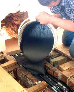 Pouring Structural Epoxy Resin into a hole in a timber beam